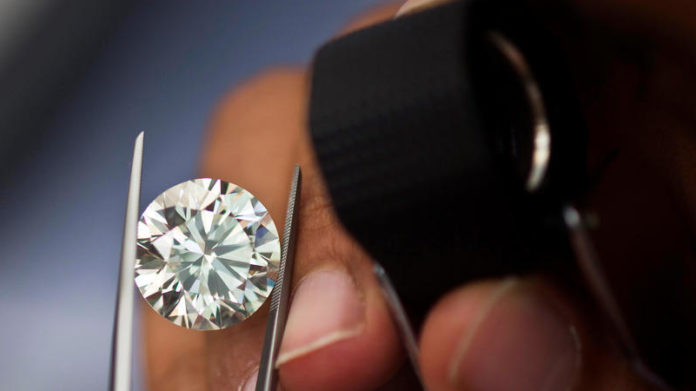 FILE PHOTO: A trader inspects a diamond during a four-day show at Israel's Diamond Exchange near Tel Aviv