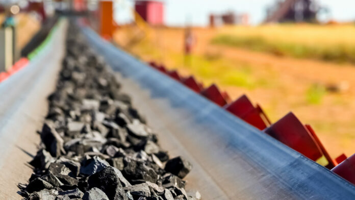 Close up of Manganese rock on a conveyor belt